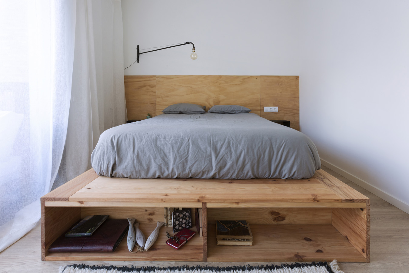 wooden double bed in stylish interior setting