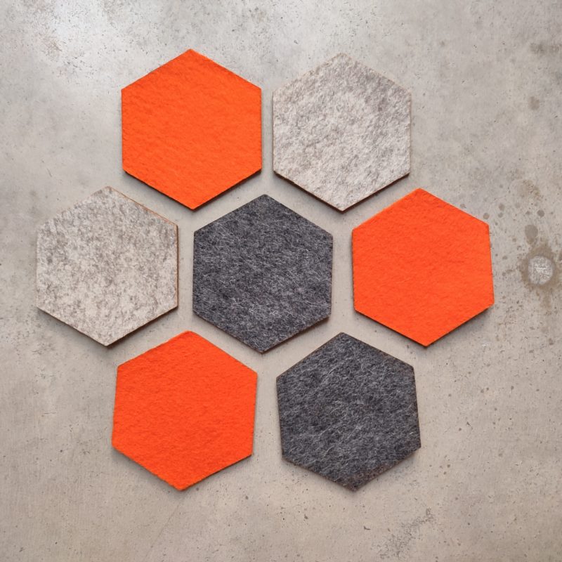 flower shaped arrangement of orange, grey and sand coloured sustainable coasters